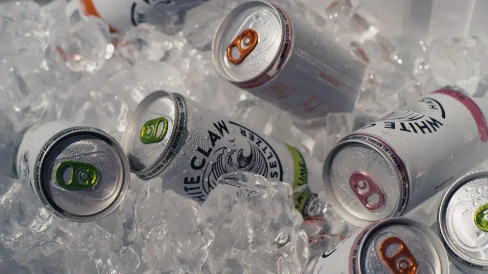 cans of white claw hard seltzer on ice