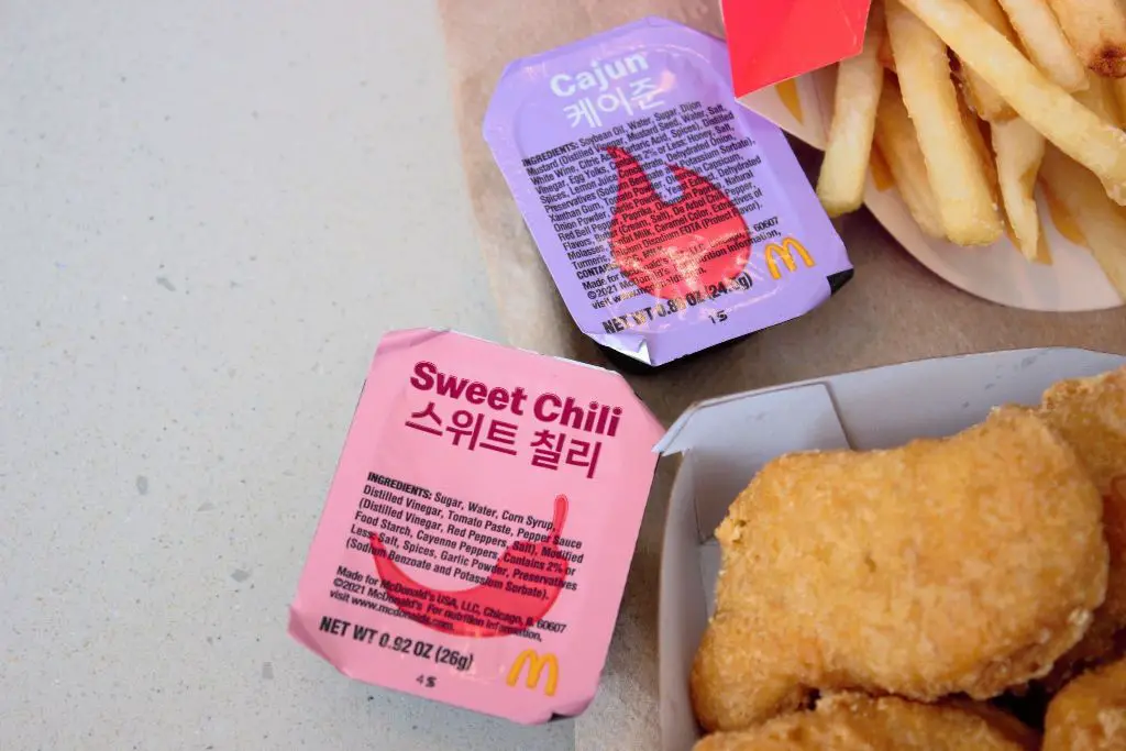 bts meal sweet chilli sauce and cajun sauce with some nuggets and fries