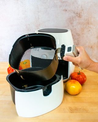 a woman taking out an air fryer basket - air fryer won't turn on
